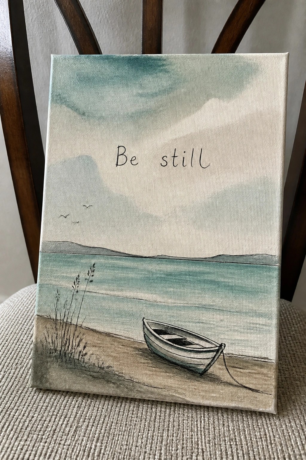 Watercolor painting of boat on shore with 