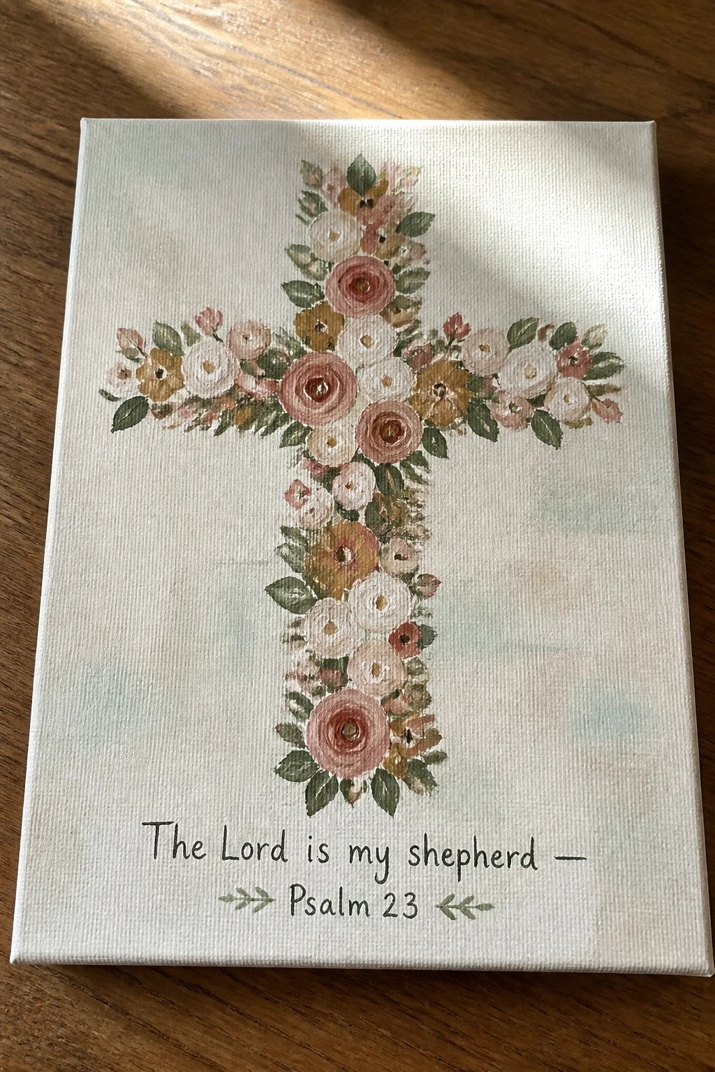 Floral cross in soft pinks and yellows on white canvas with Psalm 23 text below