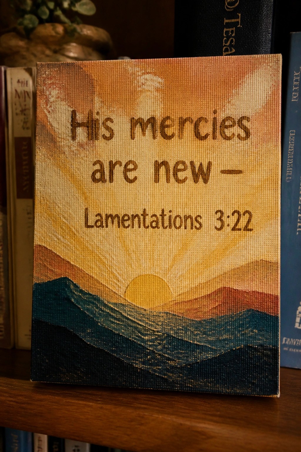 Painted canvas of sunrise over mountains with 