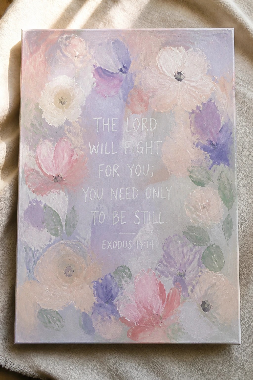 Pastel floral canvas painting with Exodus 14:14 Bible verse on beige fabric.