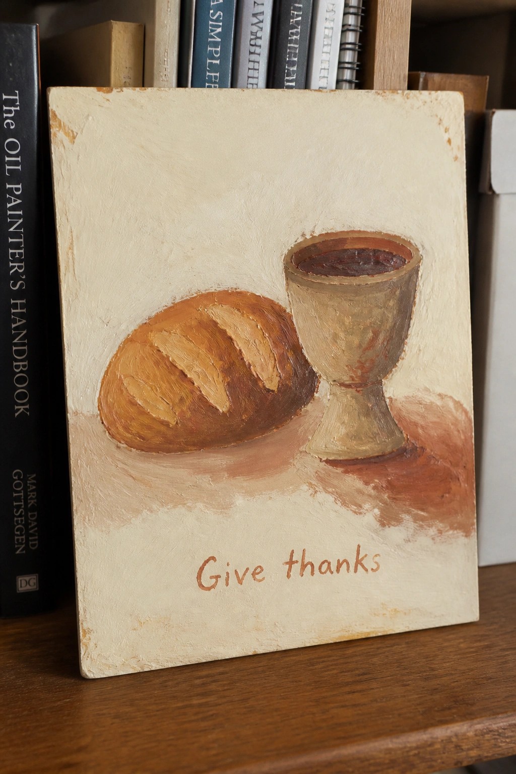 Oil painting of bread loaf and wine goblet with