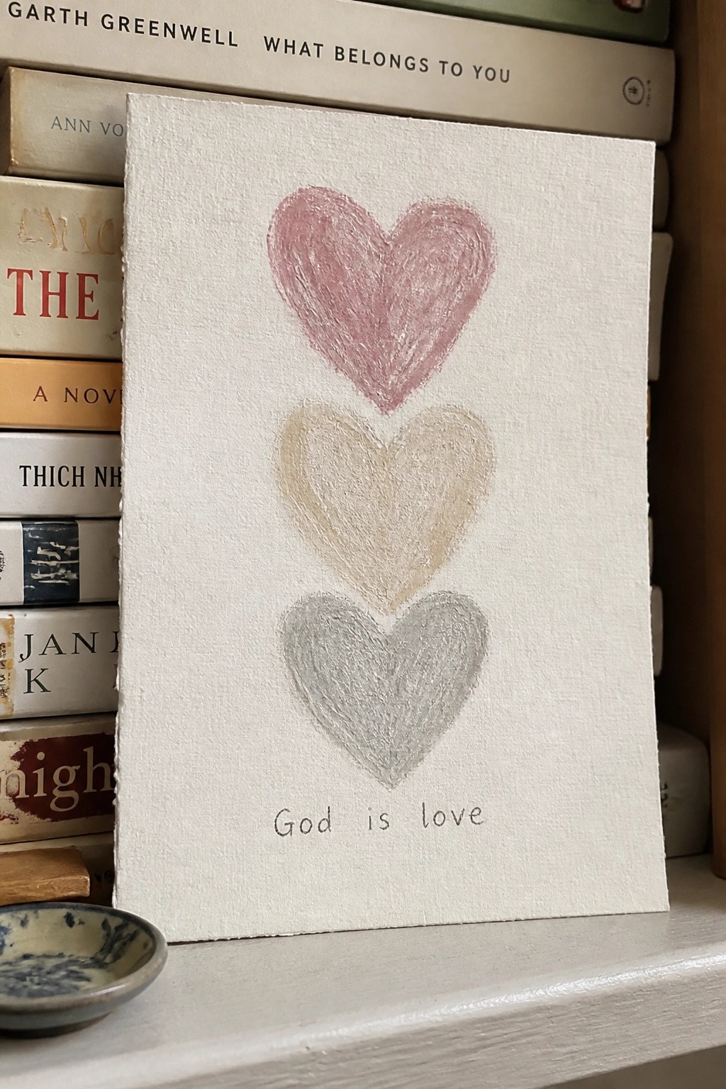 Three stacked hearts in pink, beige, and gray above