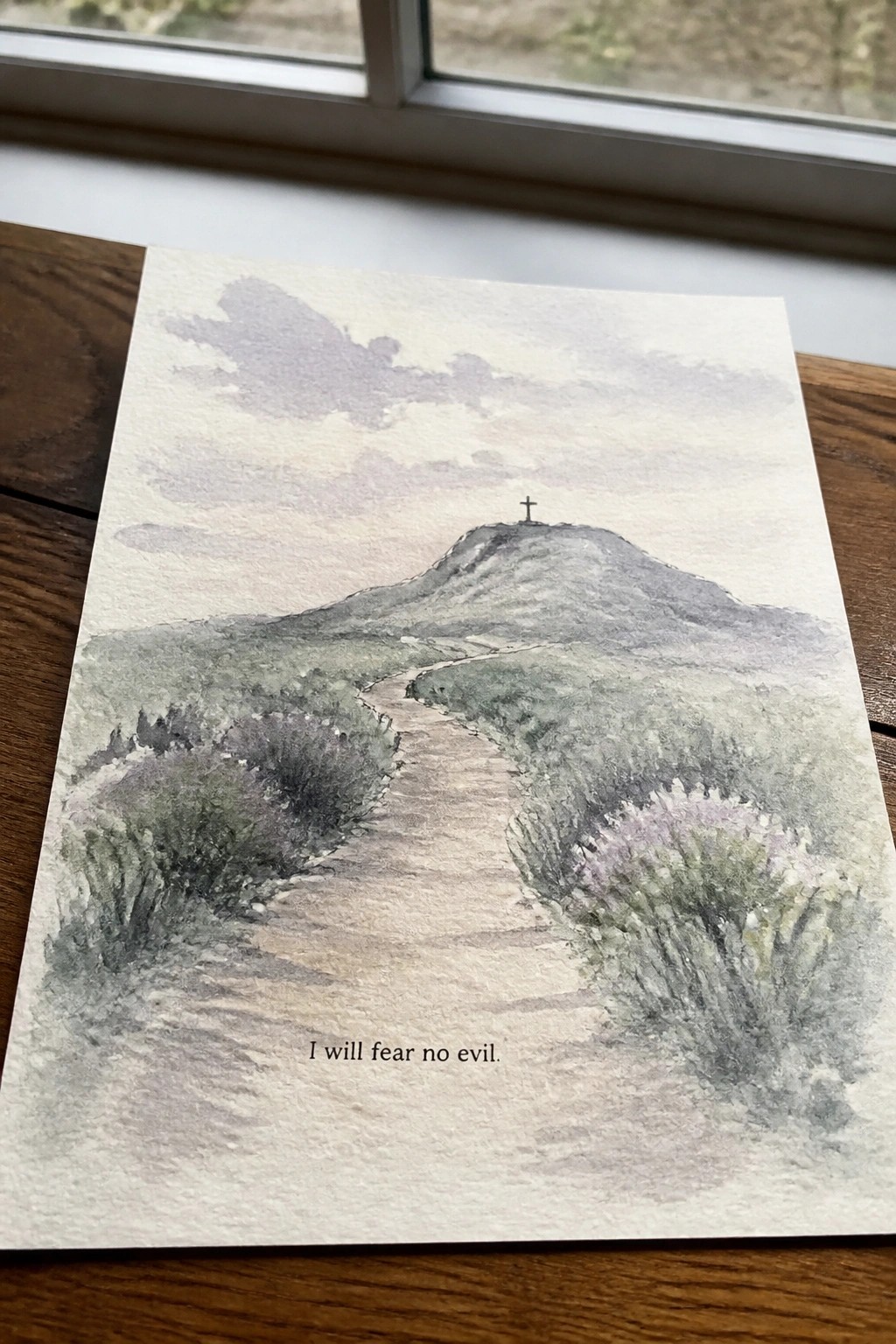 Watercolor of winding path to cross on hill amid purple bushes with