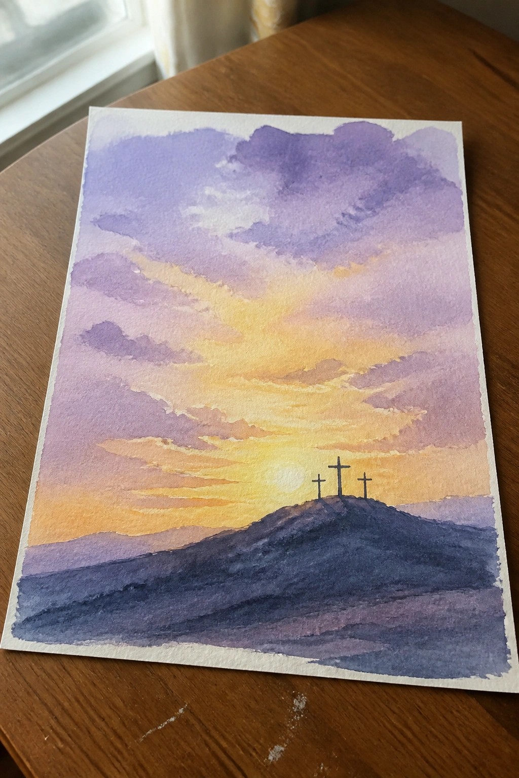 Watercolor sunset with three crosses on a hill under purple orange clouds
