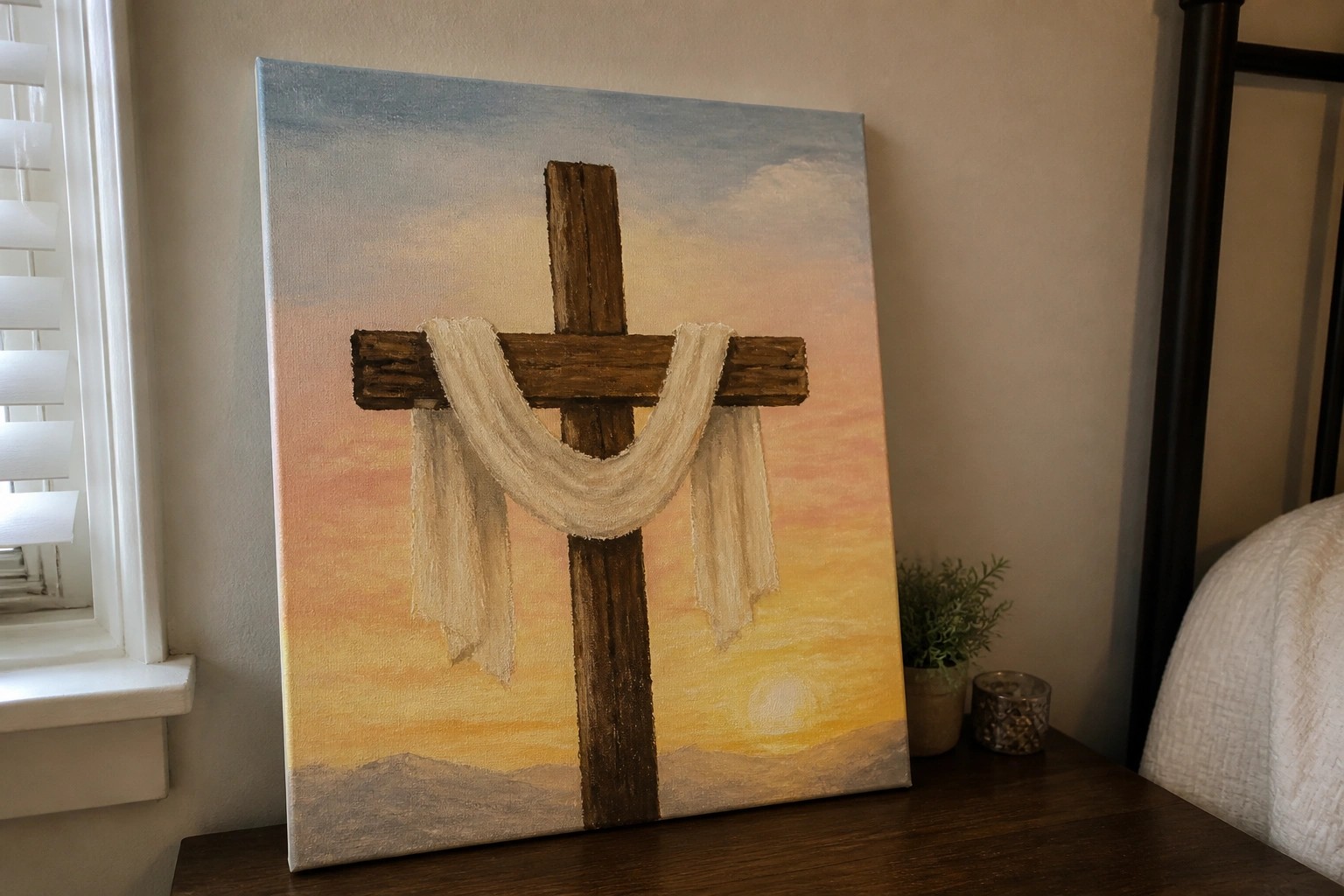 Canvas painting of wooden cross with white cloth against vibrant sunset sky