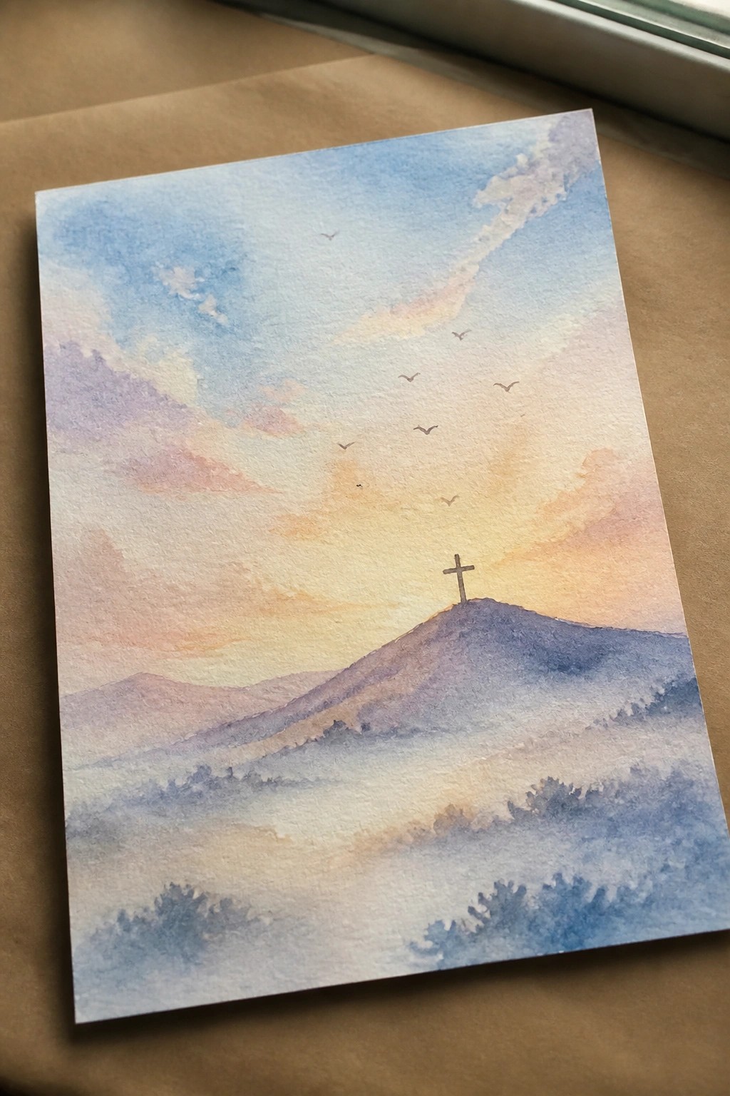 Watercolor landscape of cross on misty hill under colorful sunset sky with flying birds