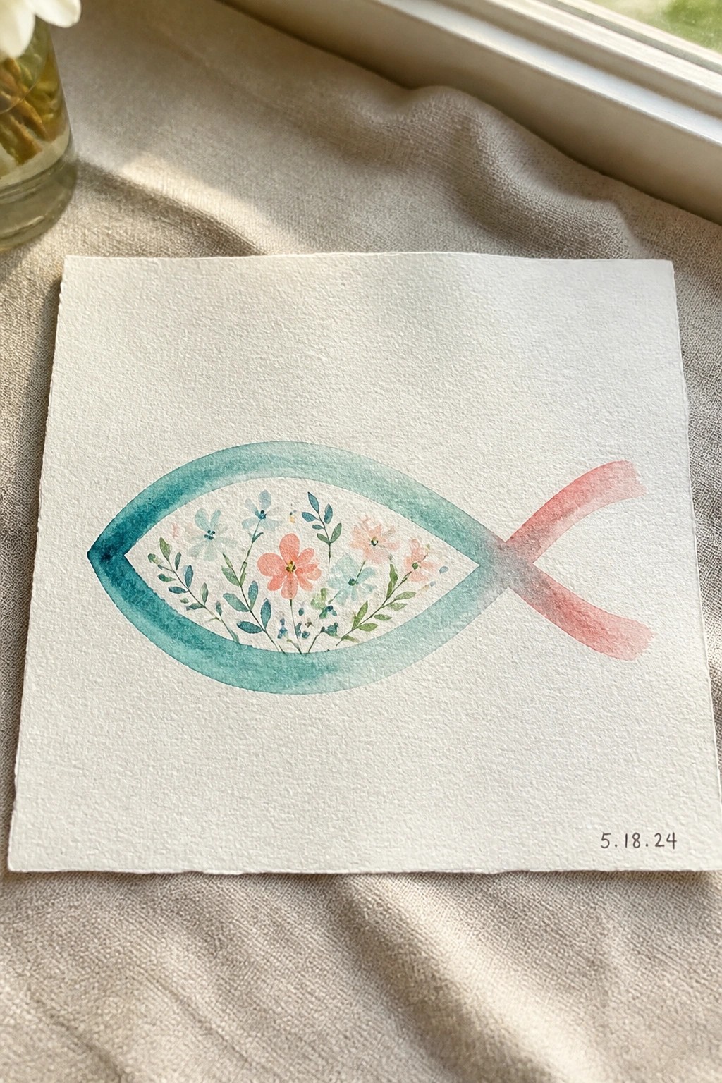 Watercolor fish outline with pink flowers and teal border on white paper