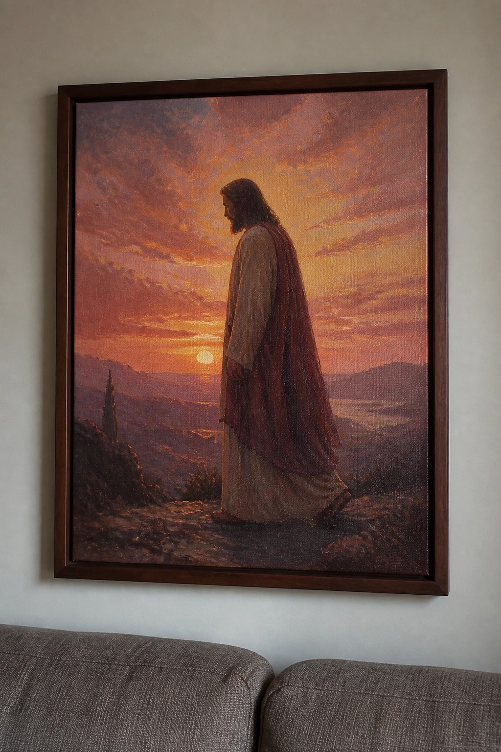 Framed painting of Jesus standing on a hillside at sunset overlooking a valley with a tower in the distance.