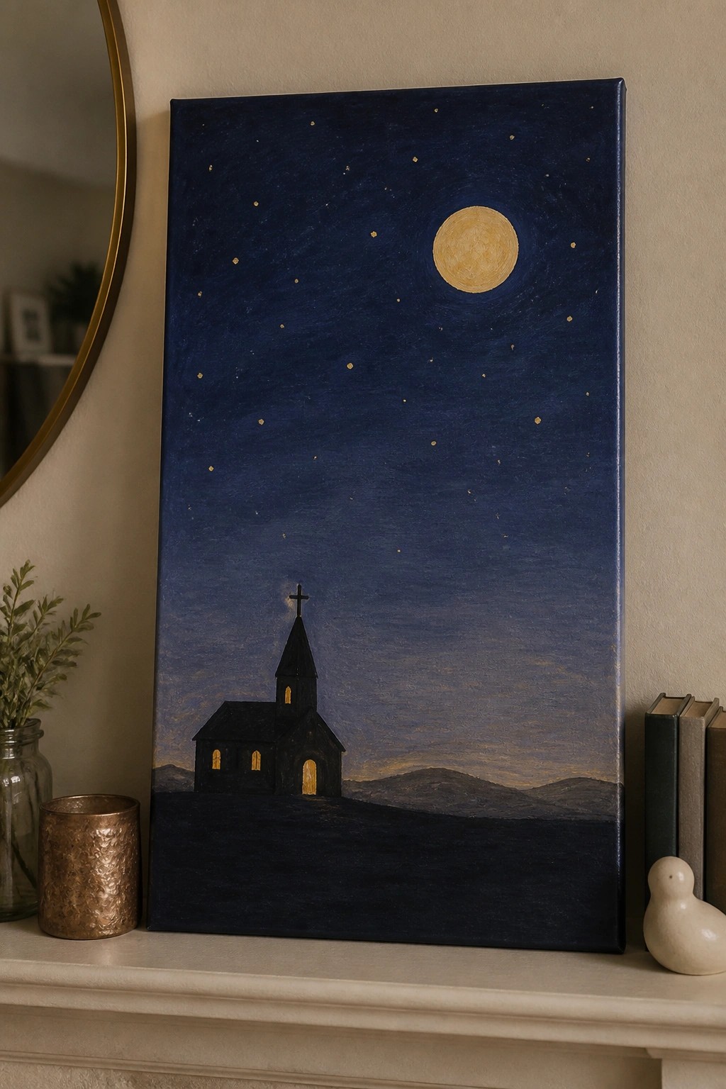 Night sky painting with full moon, stars, and black church with glowing windows on mantel.
