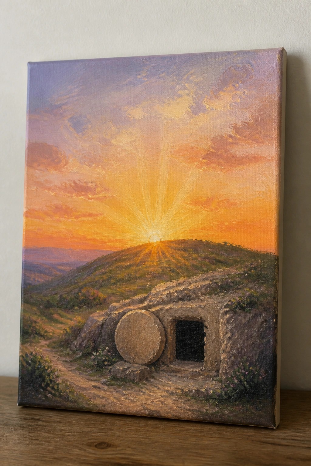 Empty stone tomb with rolled-away door at radiant sunrise over hills