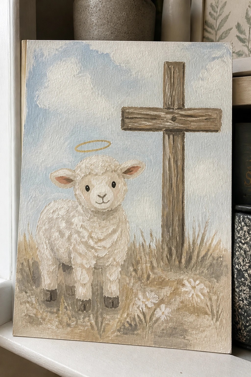 Lamb with golden halo beside wooden cross in grassy field under blue sky