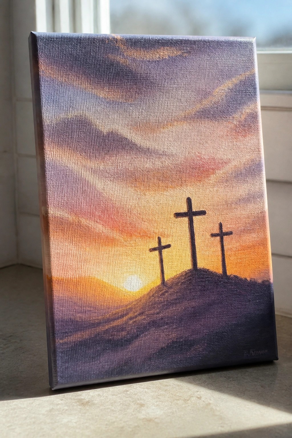 Three crosses on a hill beneath a vibrant purple-orange sunset sky on canvas.