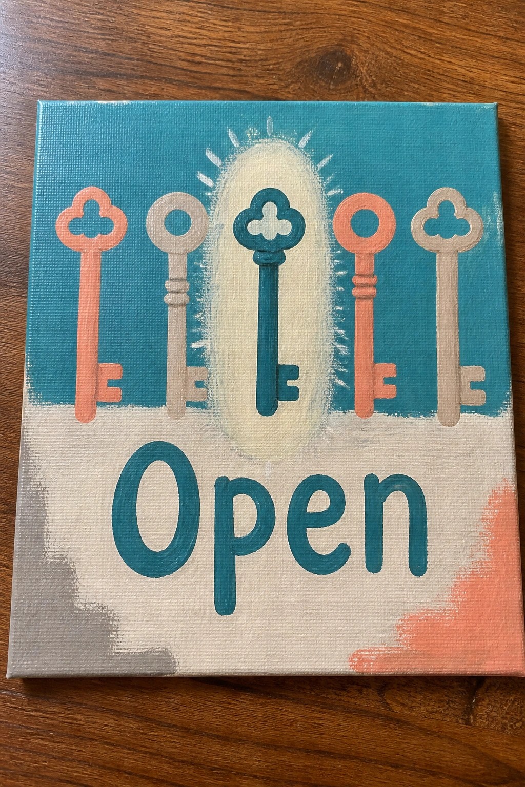 Five colorful keys above Open text on hand-painted canvas