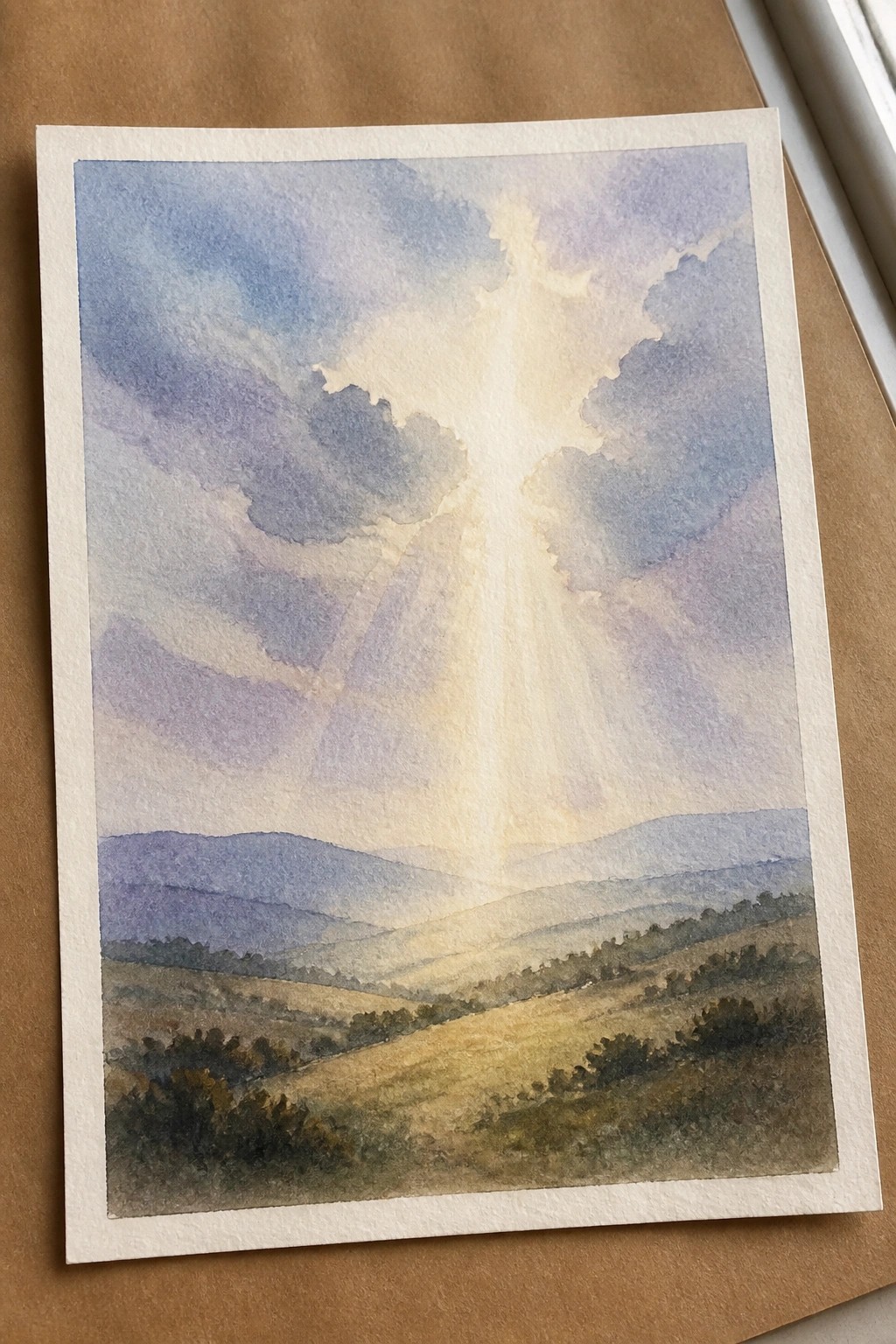 Watercolor landscape with golden sun rays piercing purple clouds above rolling hills