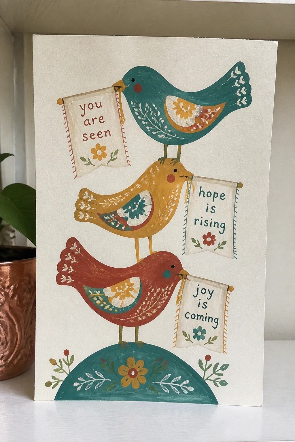 Three stacked colorful birds holding banners reading you are seen, hope is rising, joy is coming