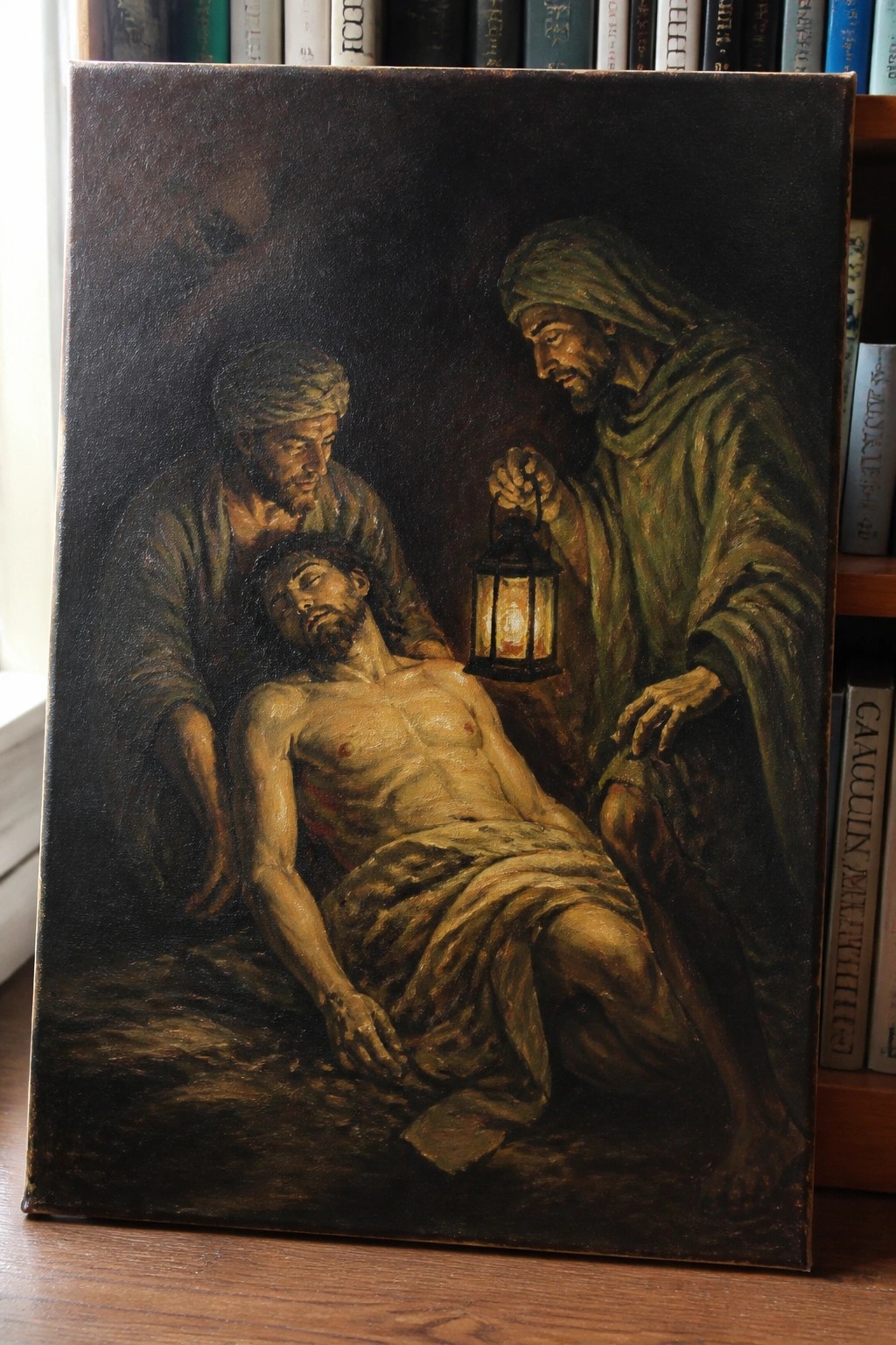 Oil painting of two robed men with lantern over wounded, shirtless figure in darkness