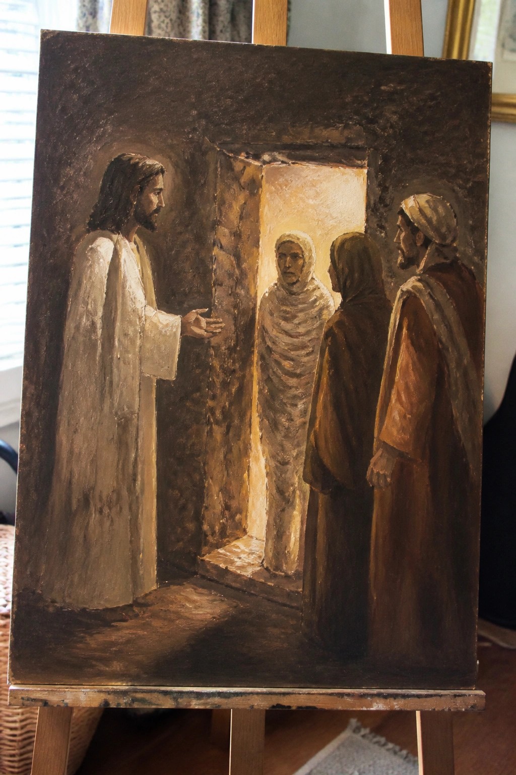 Oil painting of Jesus gesturing to bandaged Lazarus emerging from tomb with two robed figures