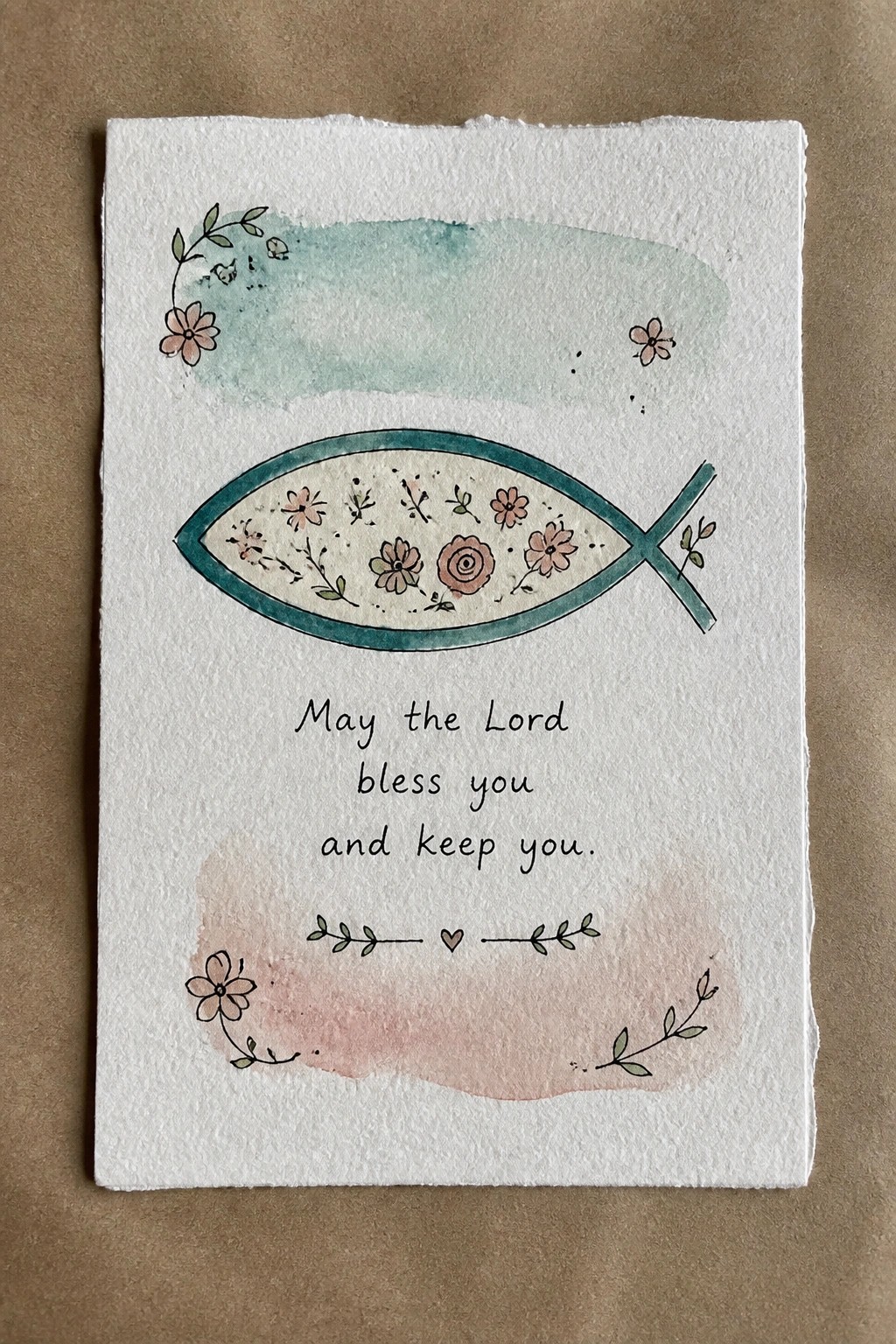 Hand-painted fish symbol with flowers on watercolor card with blessing text