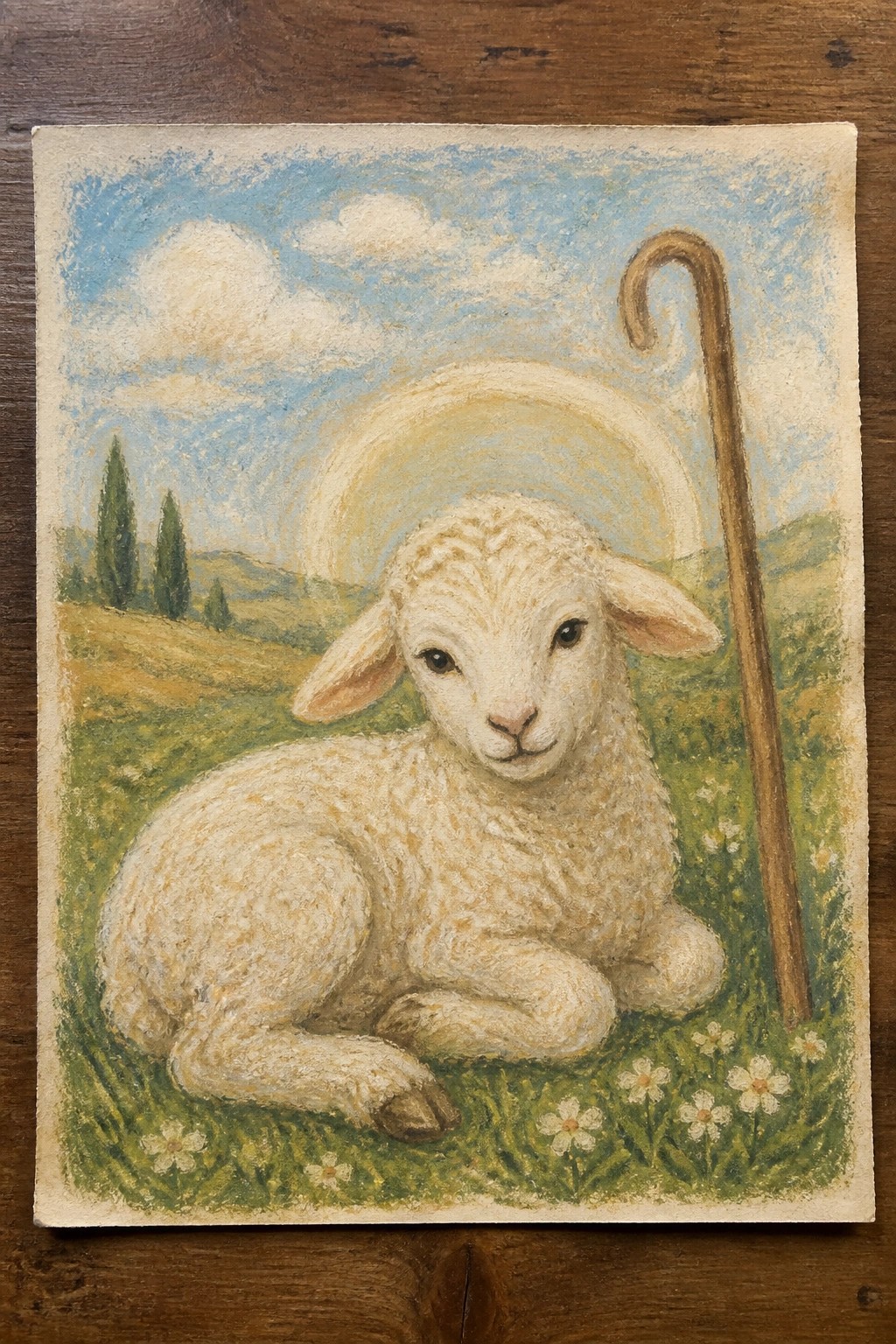 White lamb with halo resting beside wooden shepherd's crook in flowery meadow under blue sky