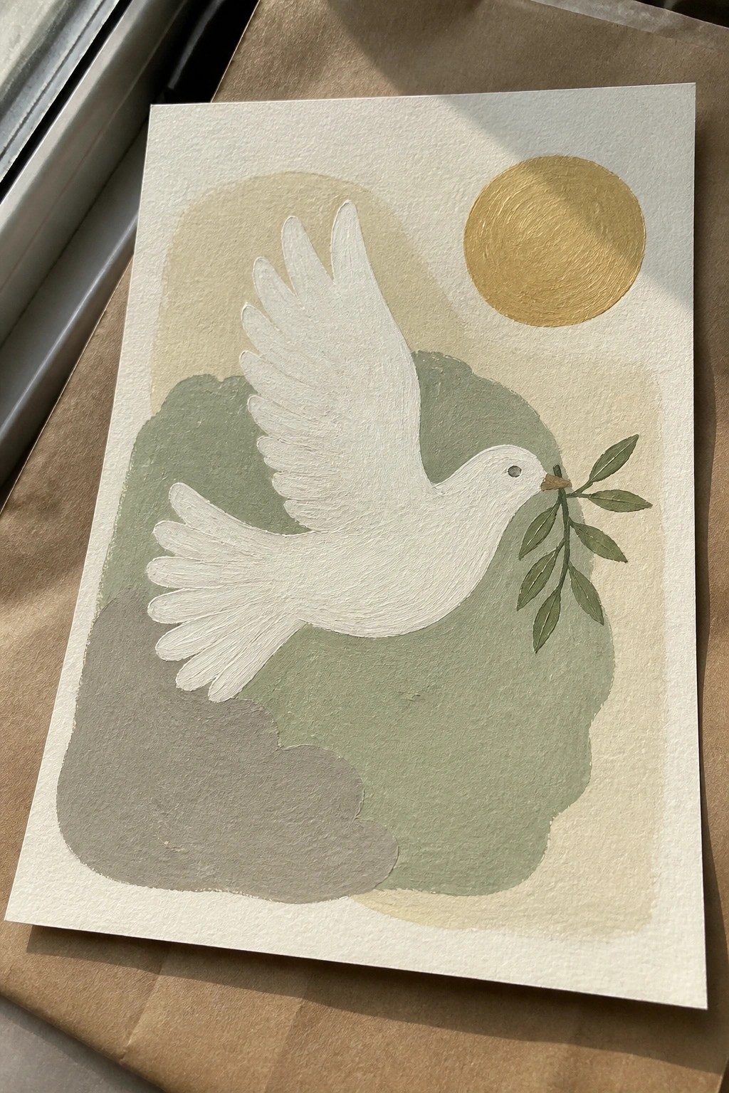 White dove in flight holds olive branch near golden sun with green abstract shapes.