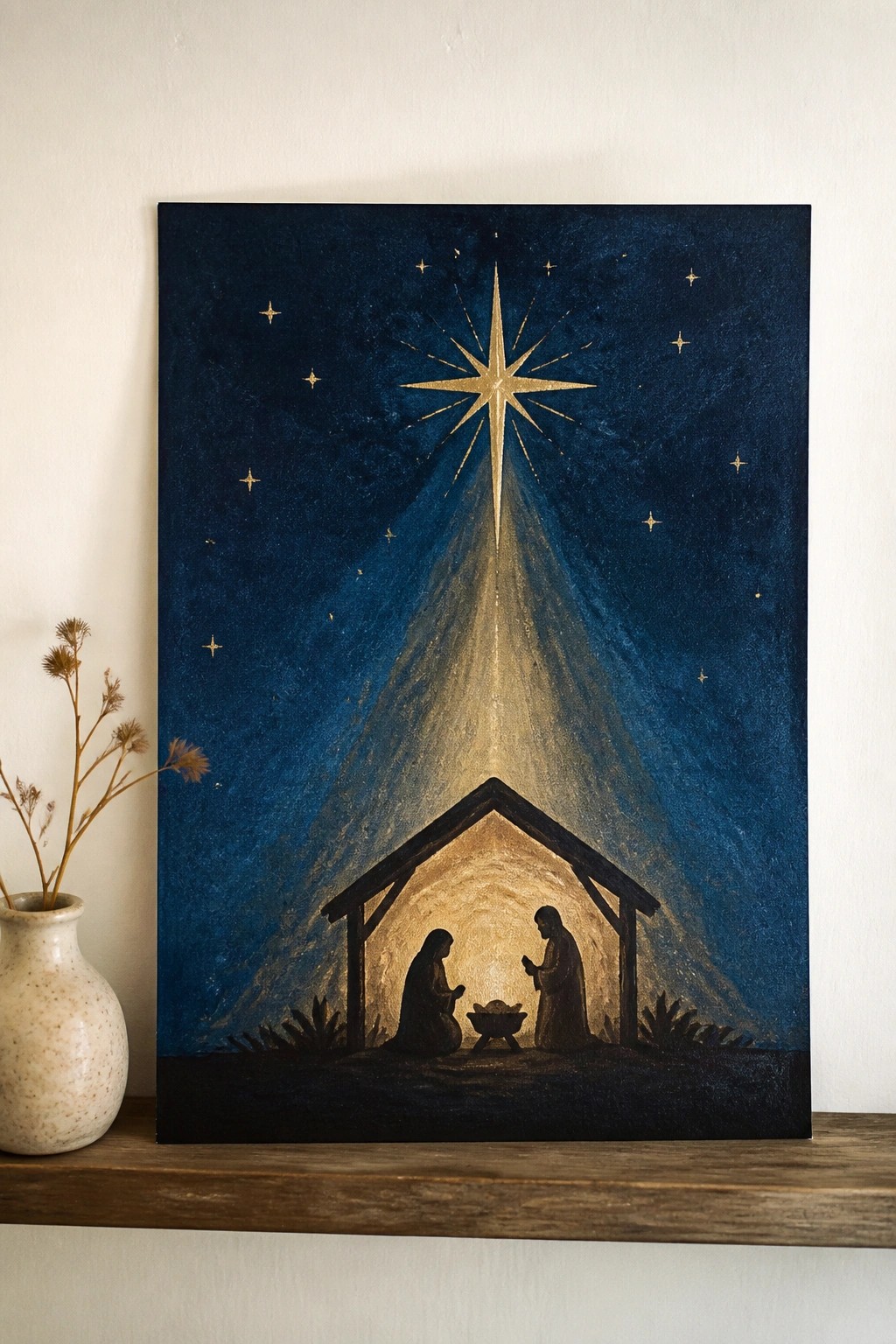 Golden star shining over nativity stable figures on wooden shelf beside vase