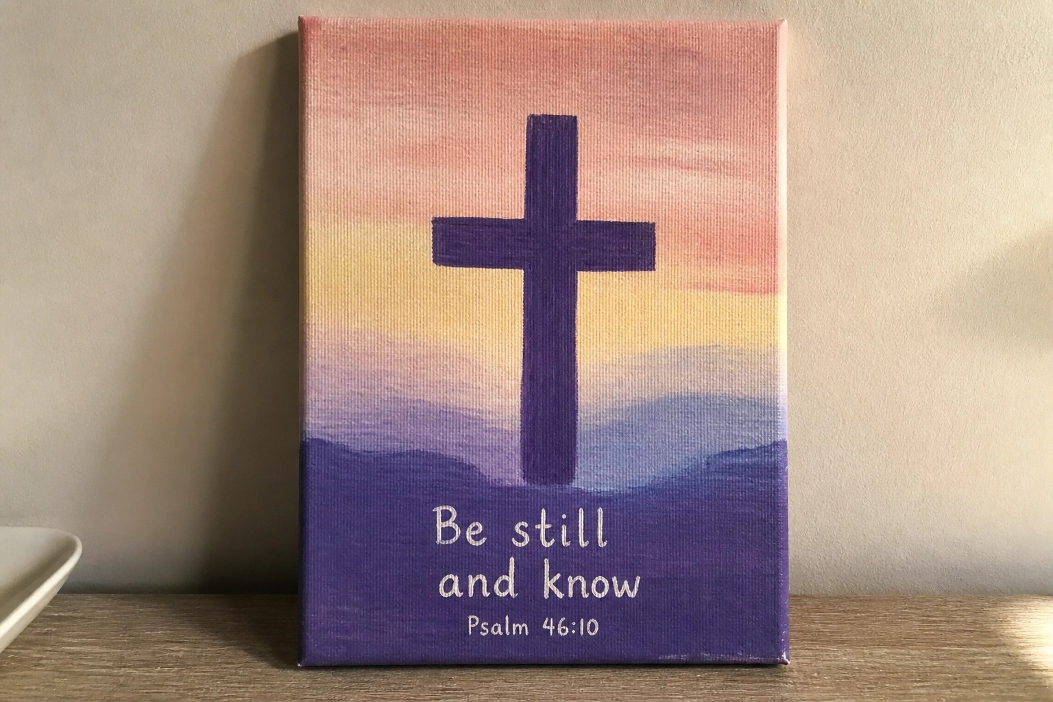 Purple cross on pastel gradient canvas with "He is Risen Matthew 28:6" text below
