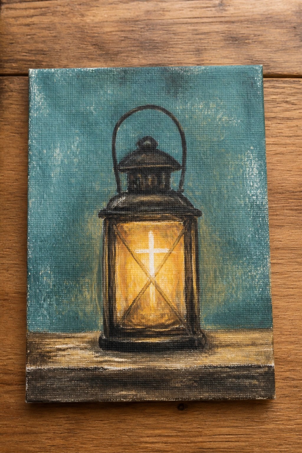 Glowing black lantern with white cross on wooden ledge against teal background