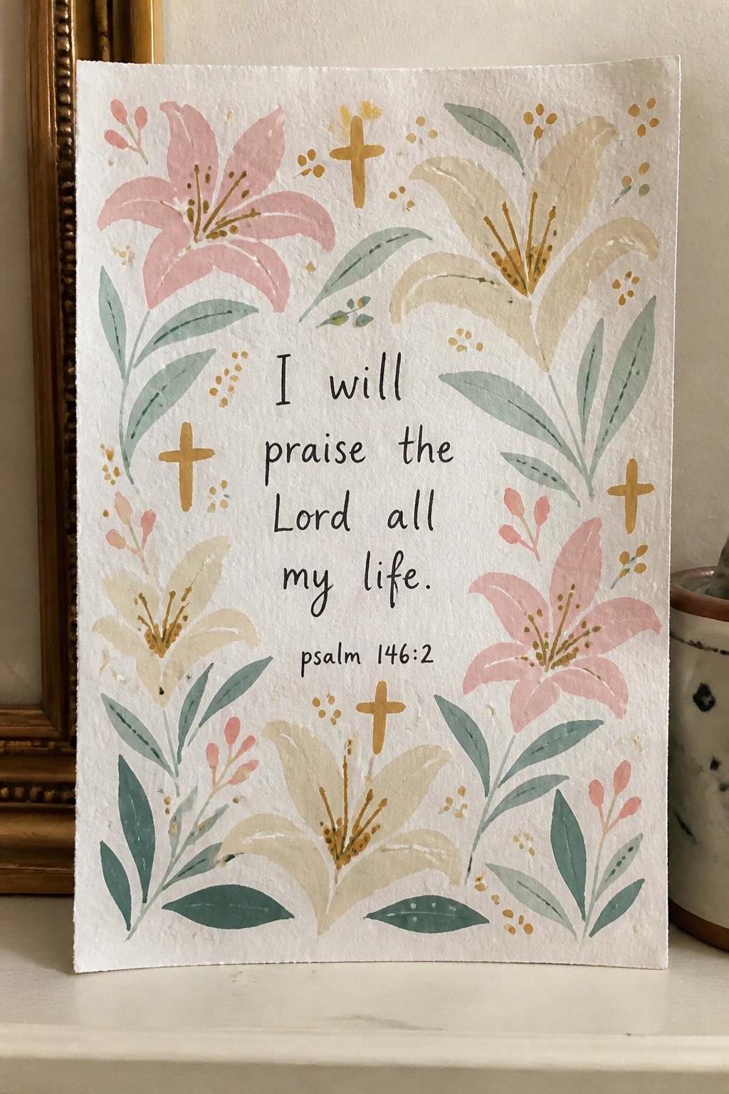 Watercolor card with pink lilies, green leaves, golden crosses, and Psalm 146:2 quote