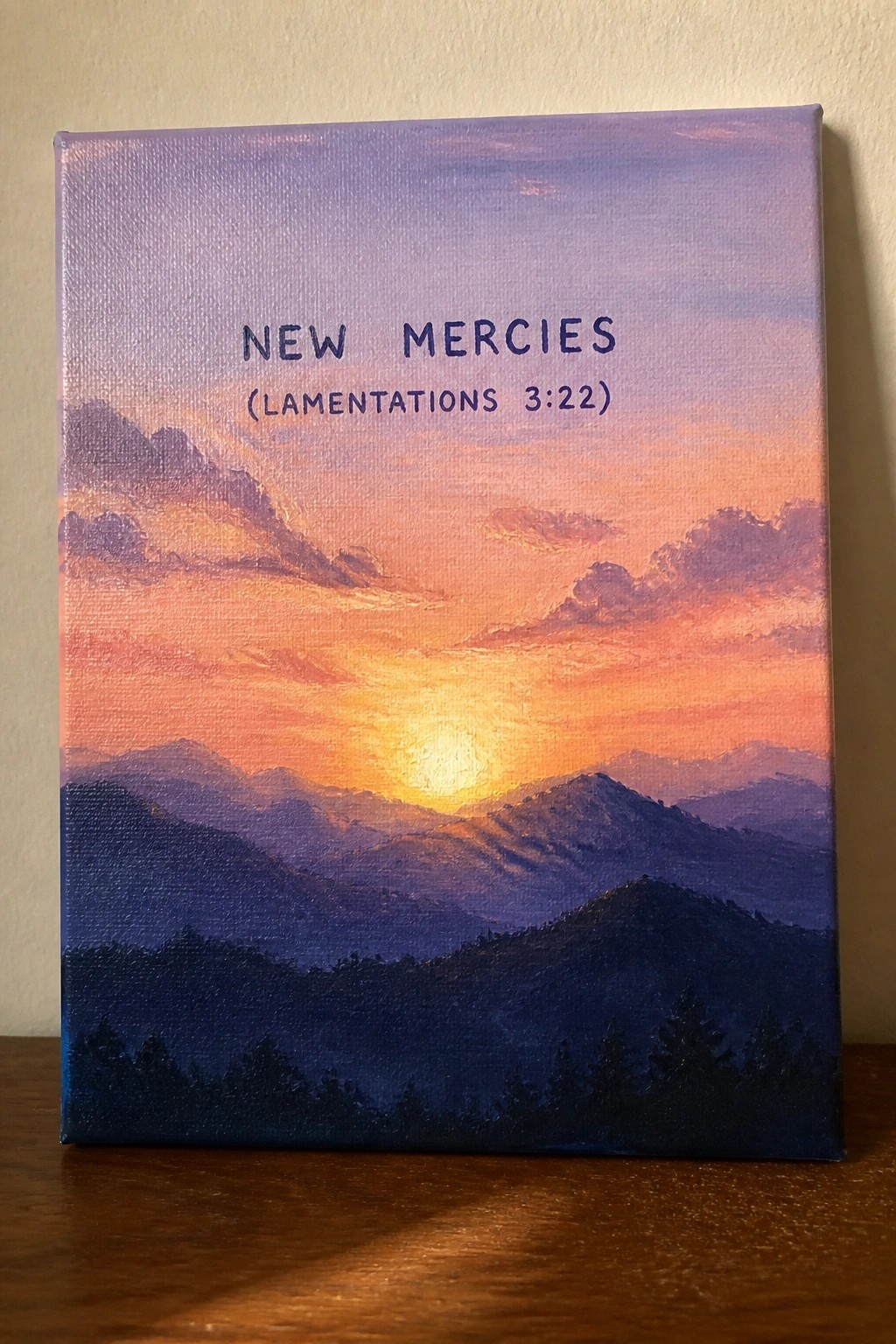 Canvas painting of vibrant sunset over layered mountains with 