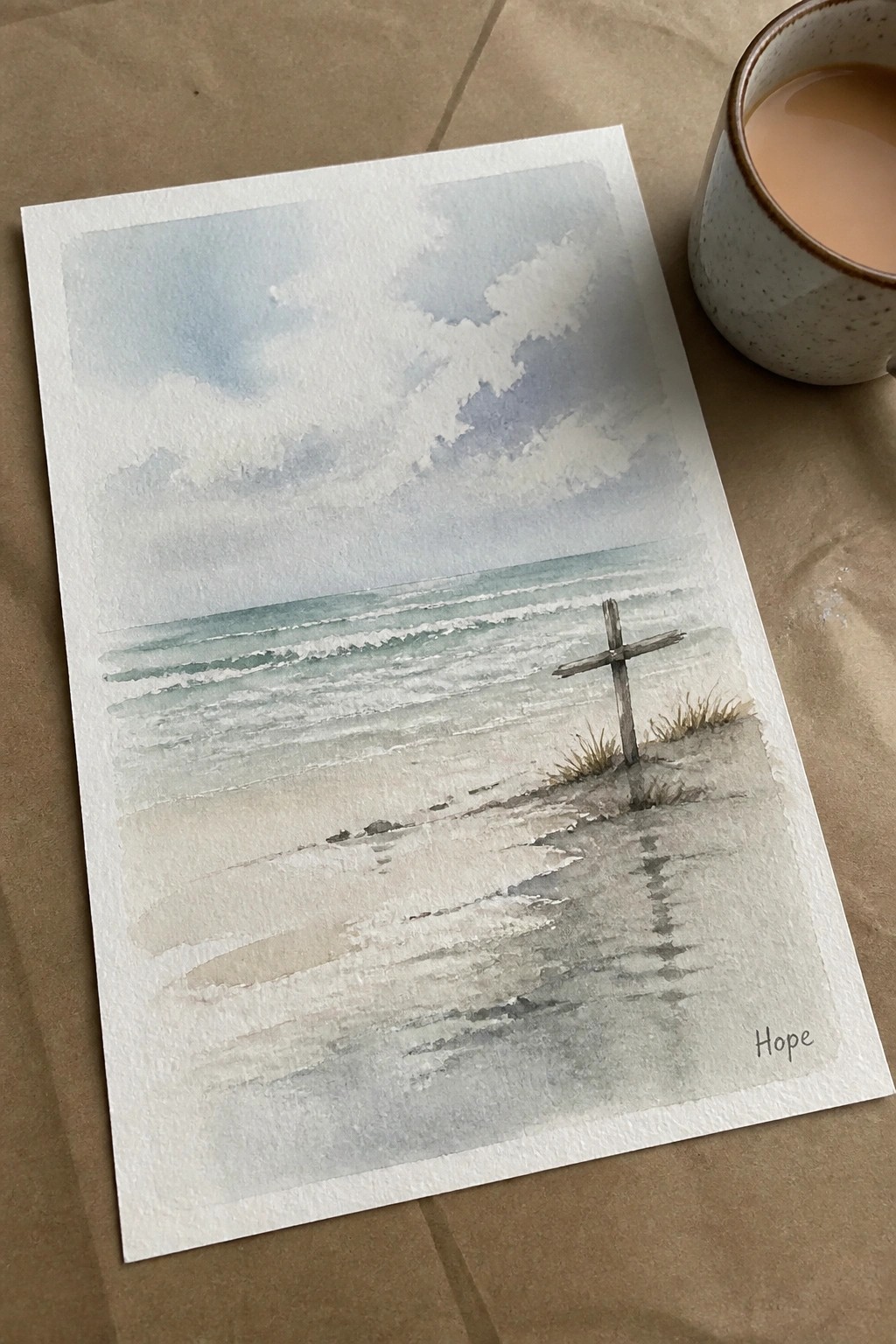 Watercolor beach scene with wooden cross on sand, ocean waves, and