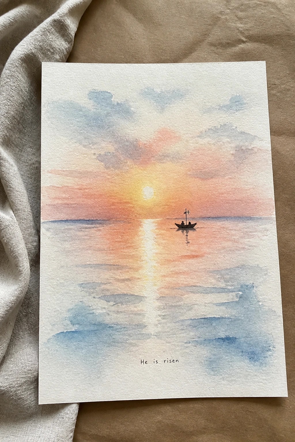 Watercolor sunset seascape with small boat on horizon, glowing sun reflection, and