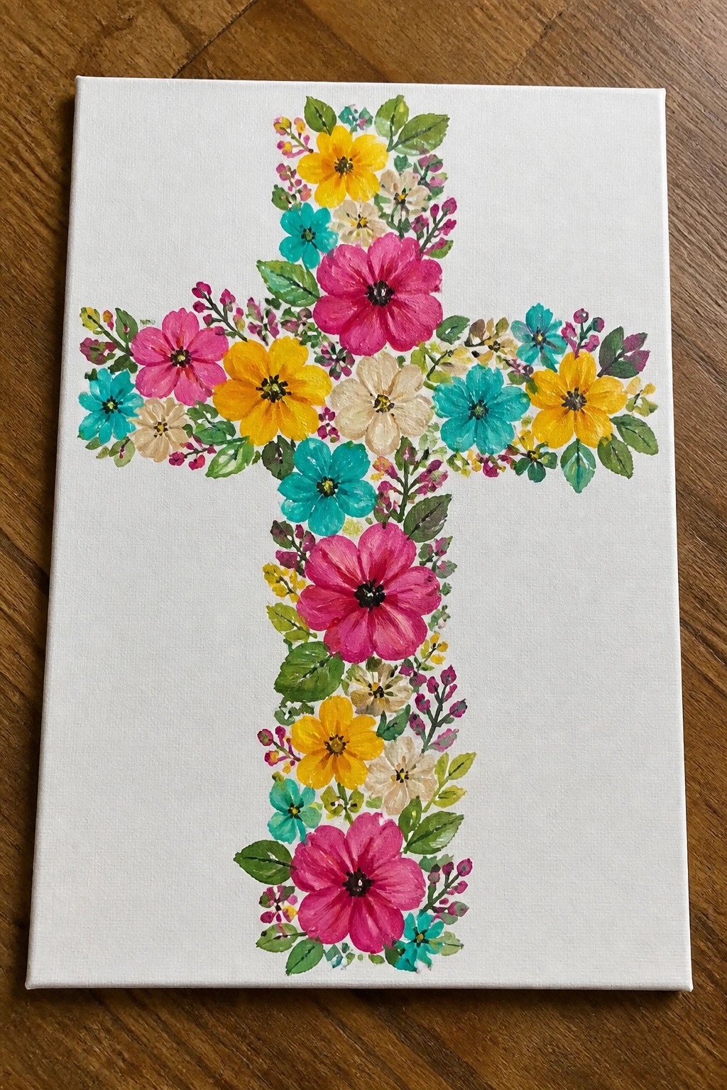 Vibrant floral cross in pink, yellow, and turquoise on white canvas over wood
