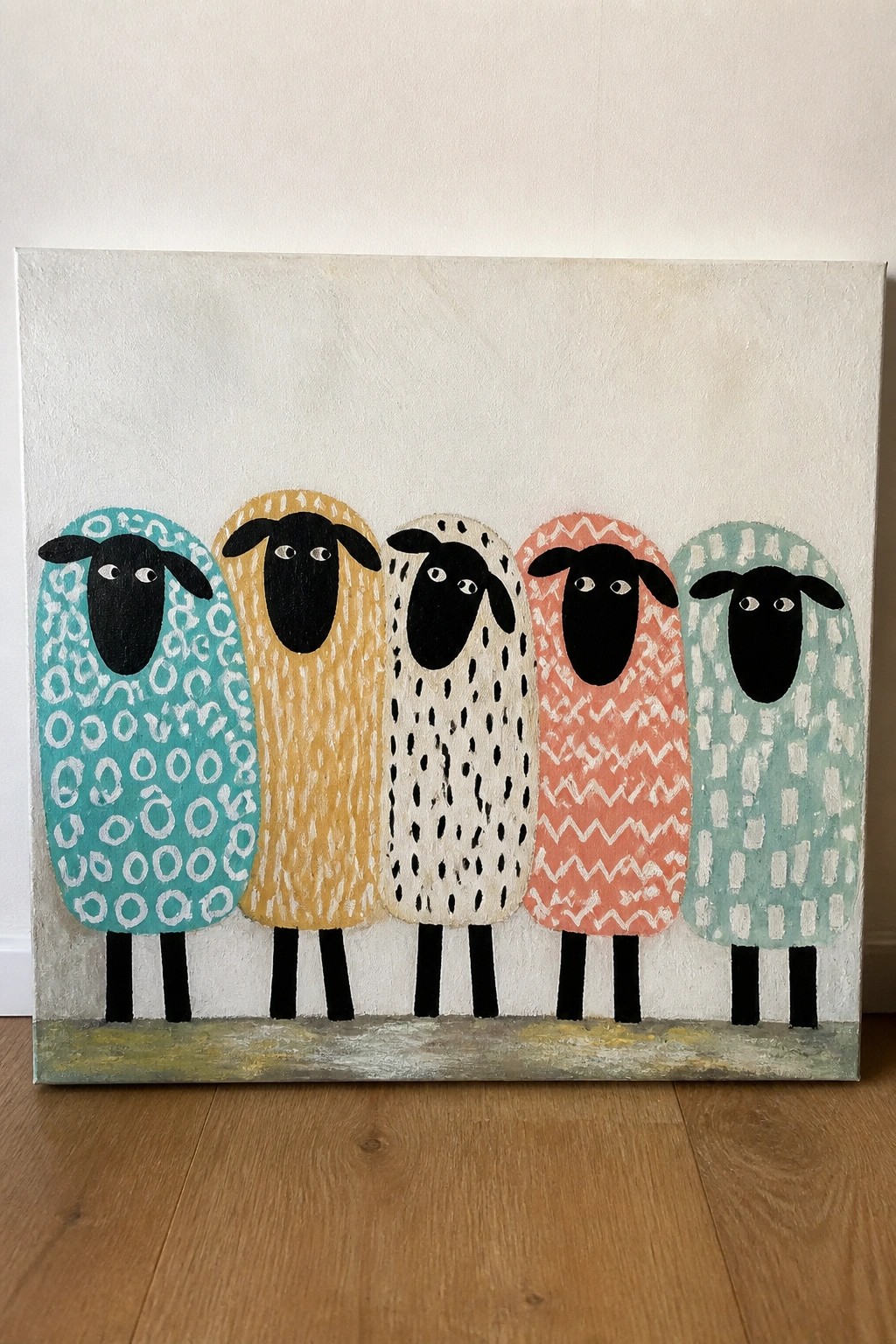 Five sheep with colorful patterned bodies and black heads in folk art style