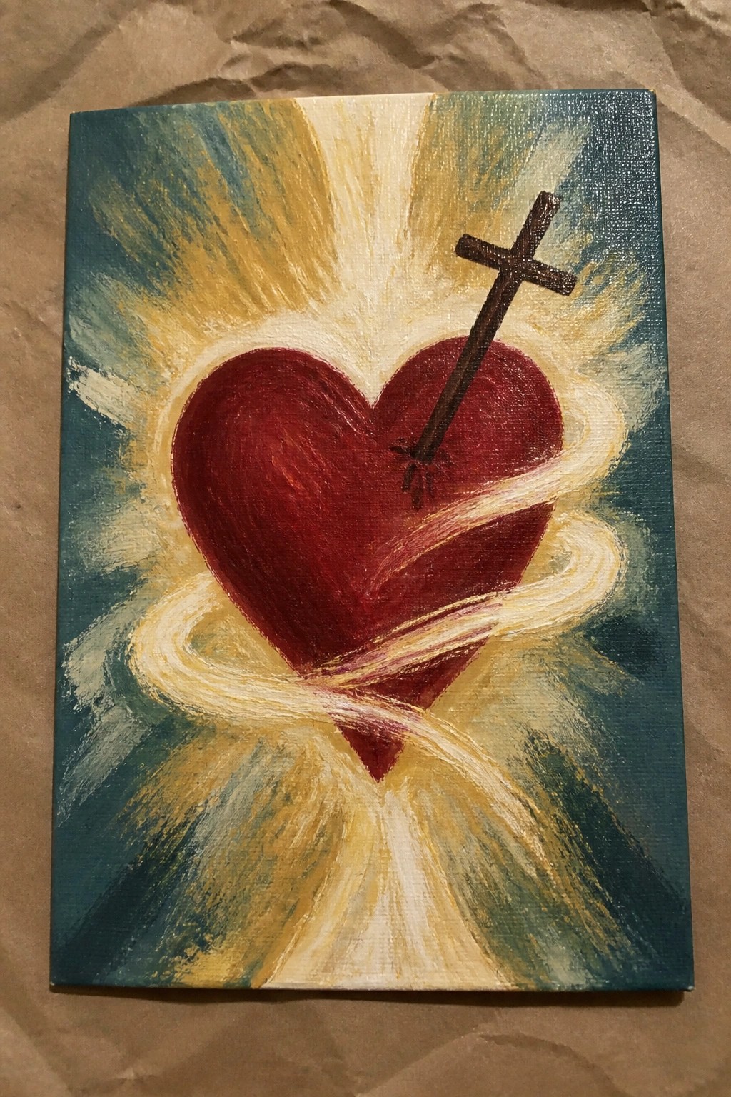Red heart pierced by cross, encircled by swirling yellow-white ribbons on teal background
