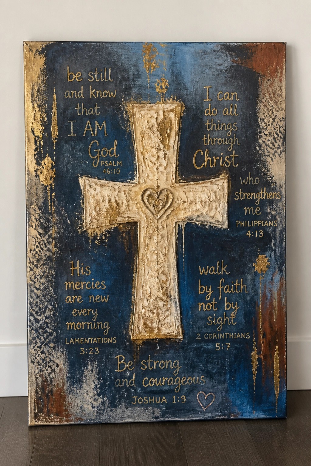 Textured blue-gold canvas with raised cross, heart, and gold Bible verses.