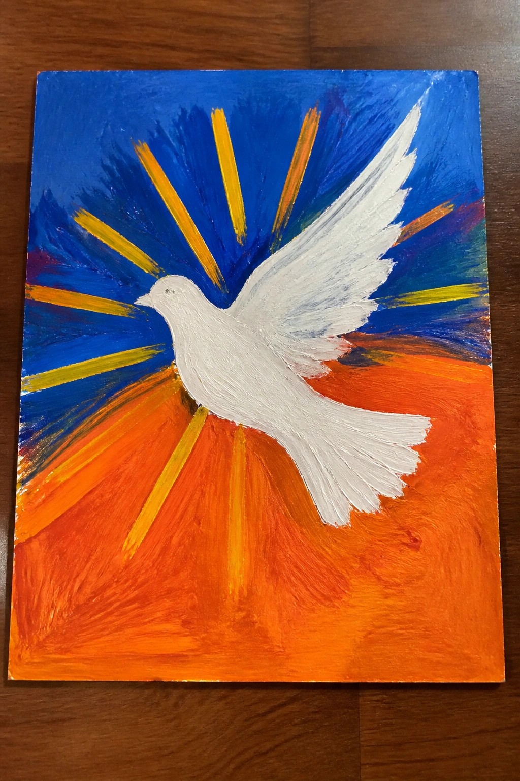 White dove soaring amid blue sky and orange sunset with yellow radiating rays