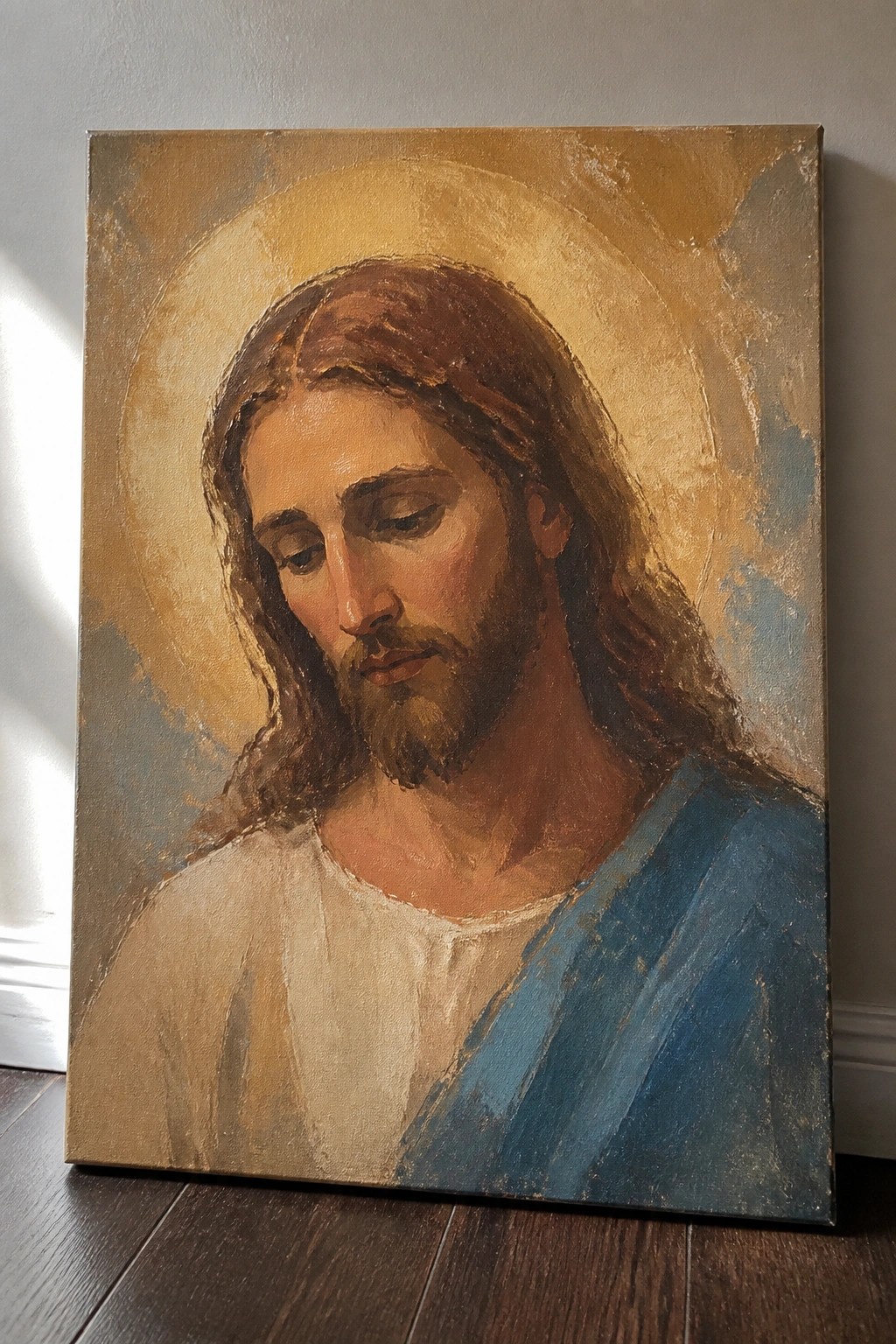 Jesus with long brown hair and beard in white robe with blue cloak and golden halo.