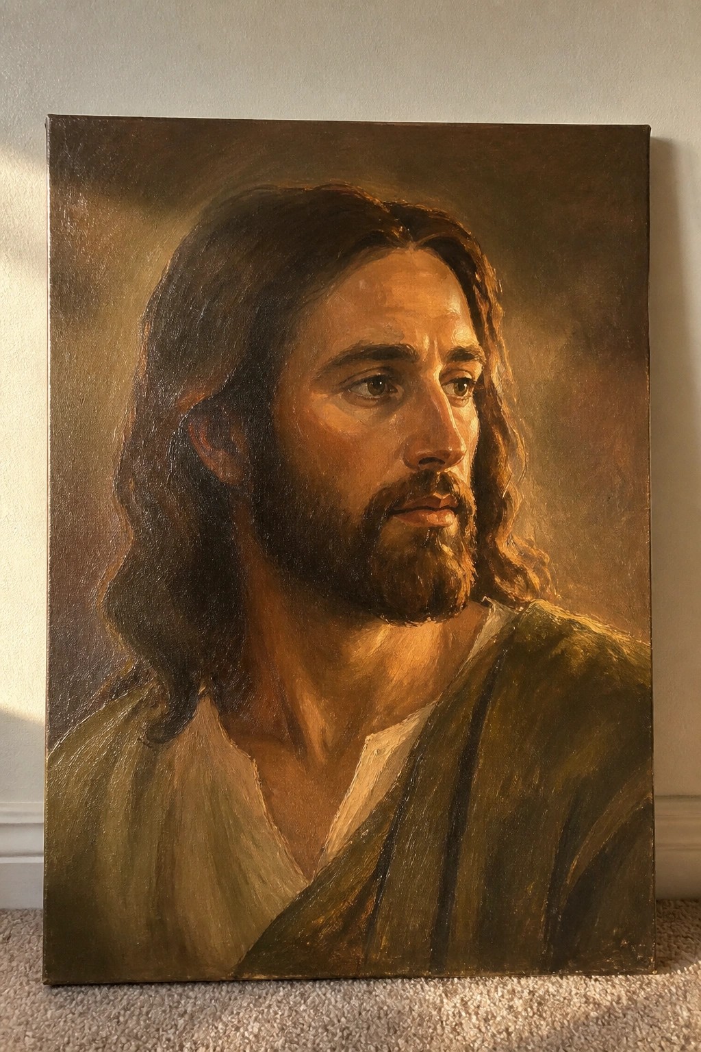Oil painting of Jesus with long brown hair, beard, and green robe gazing right