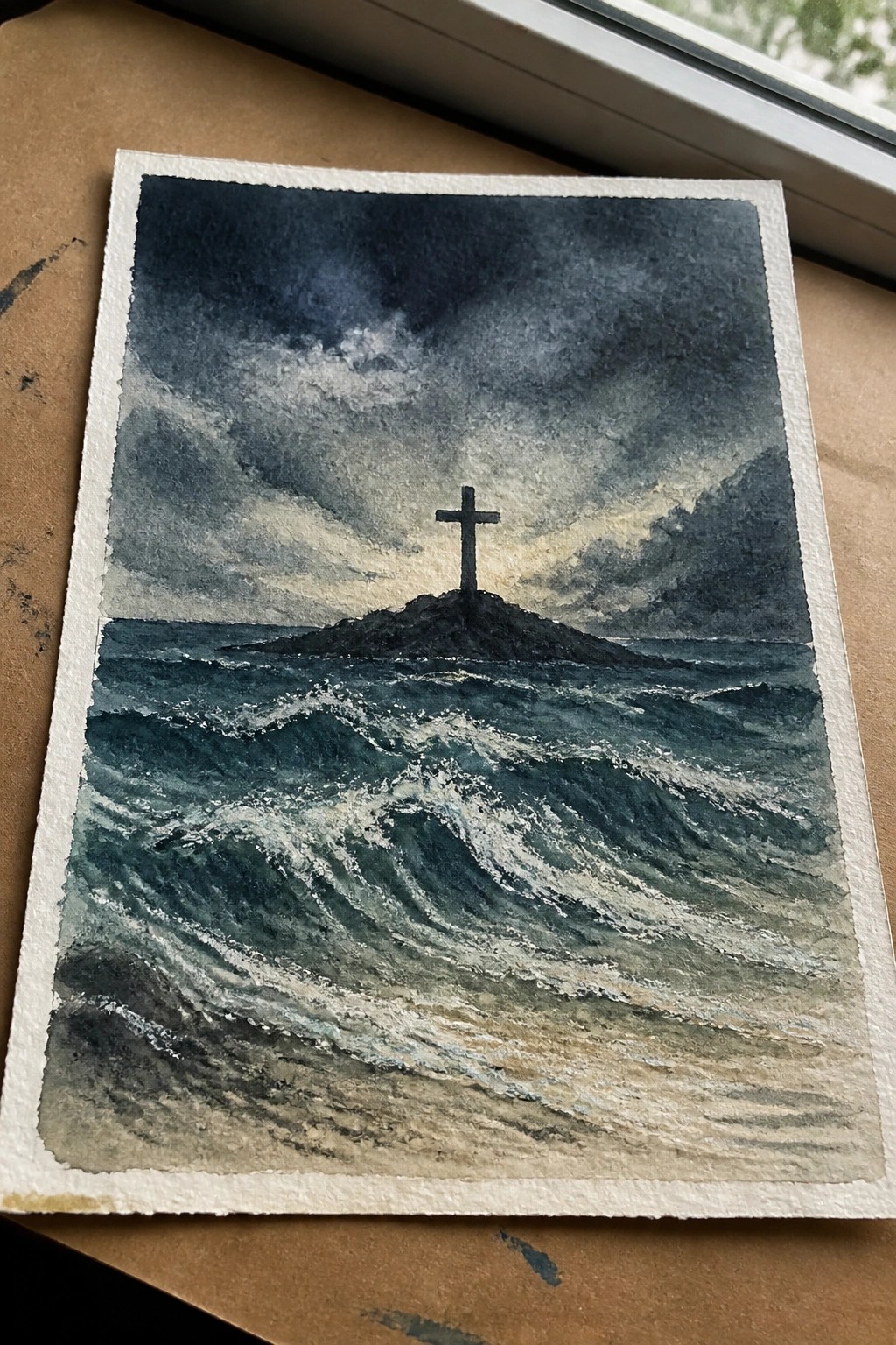 Watercolor seascape of stormy waves crashing near a cross on a rocky island under dark clouds