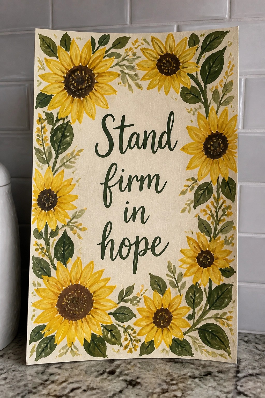 Yellow sunflowers with green leaves border cursive text 