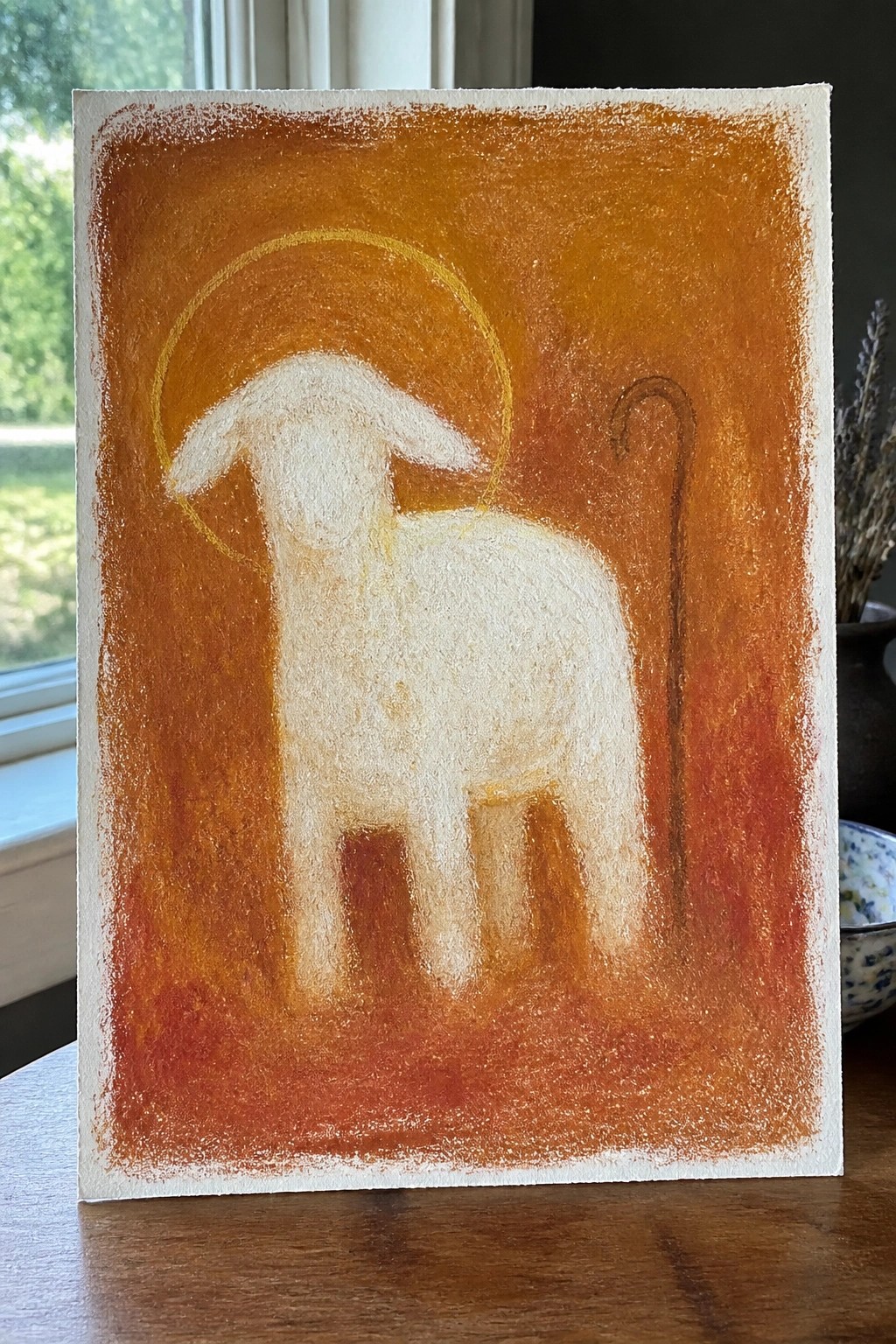 White lamb with golden halo beside shepherd's crook on textured orange background