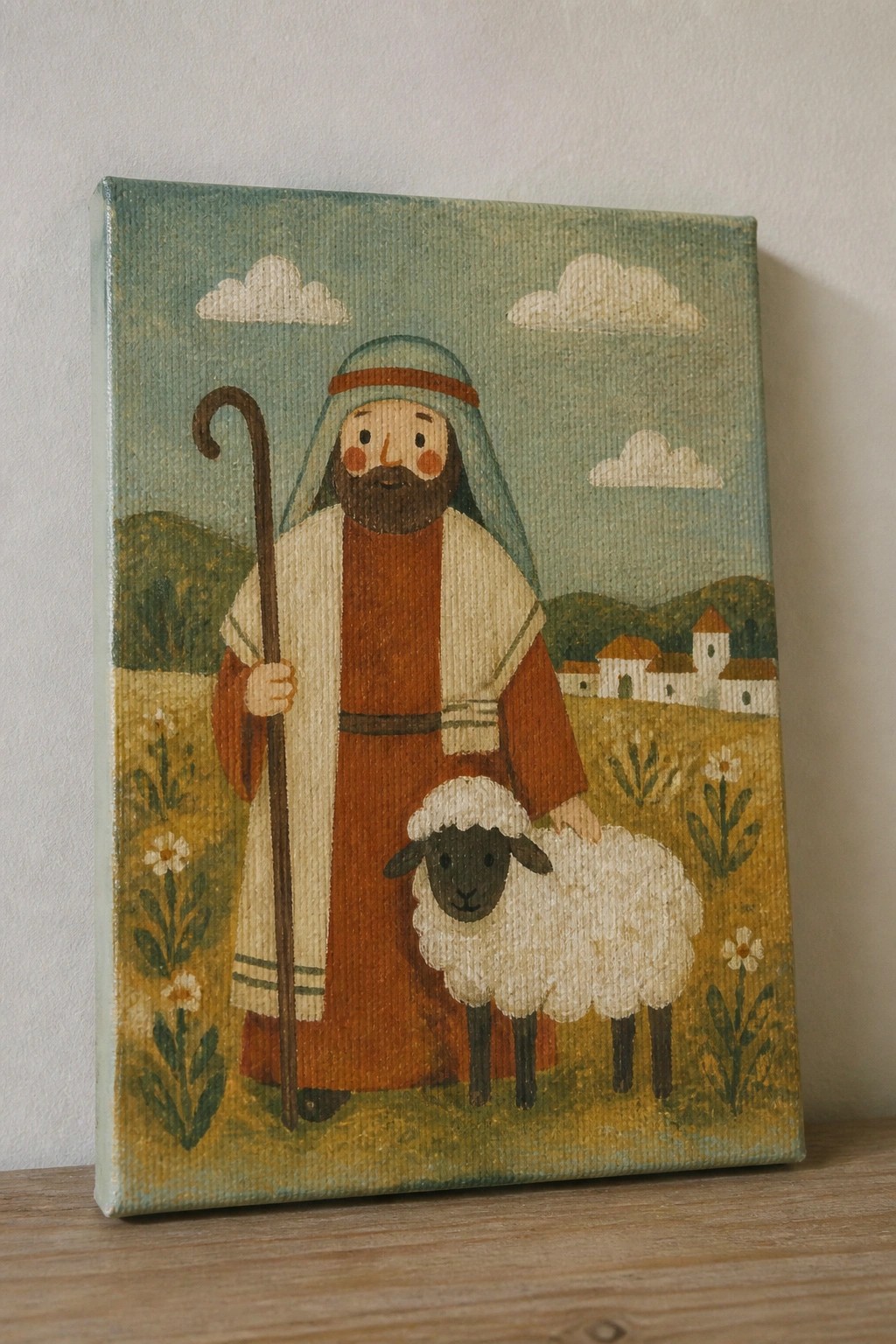 Shepherd in brown robe with staff beside black-faced sheep in flowery meadow landscape