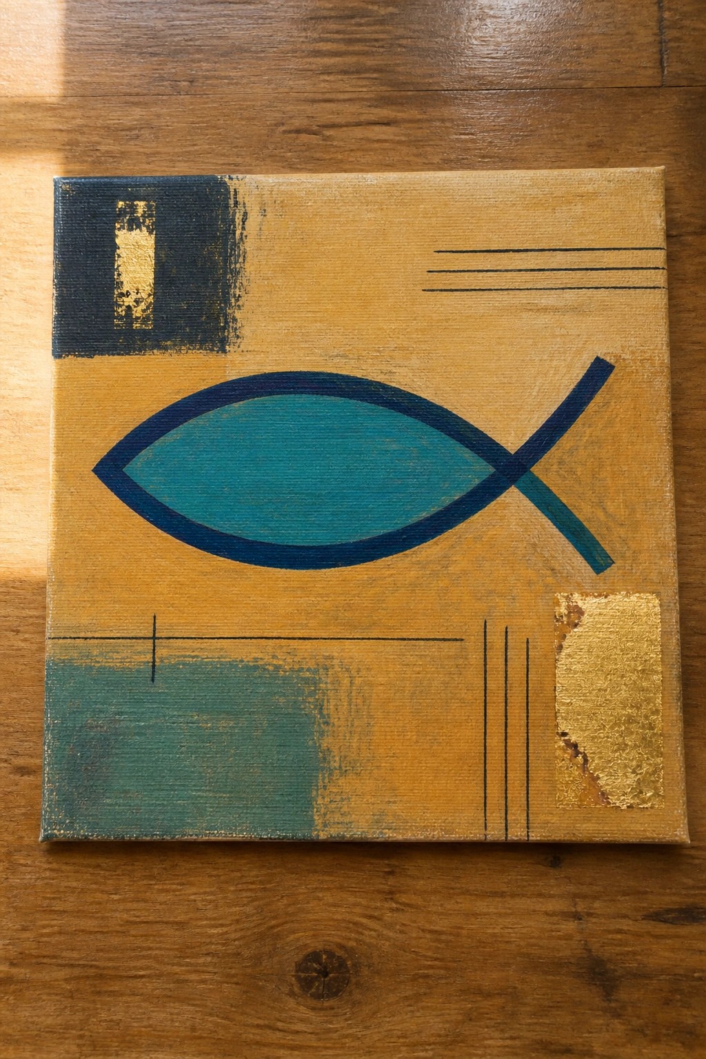 Abstract painting of teal fish symbol with gold accents on yellow canvas