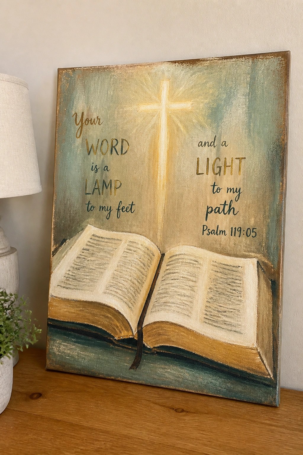 Canvas painting of open Bible beneath glowing cross with Psalm 119:05 text in teal and gold