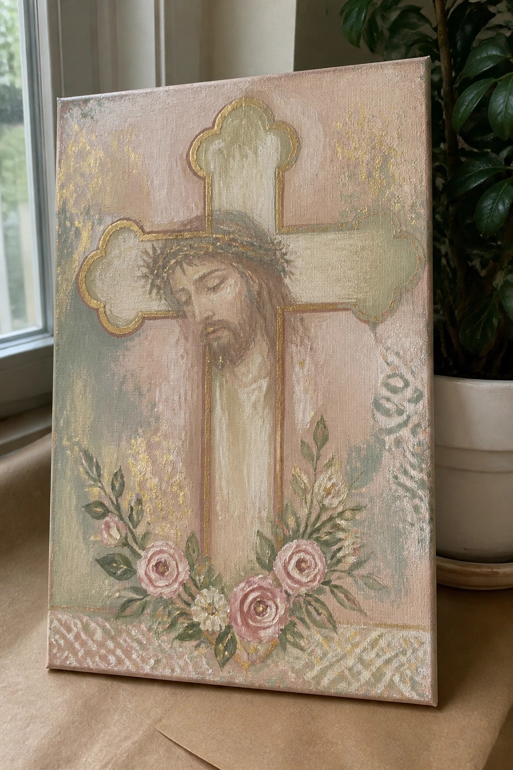 Canvas painting of Jesus on ornate gold-trimmed cross with pink roses below