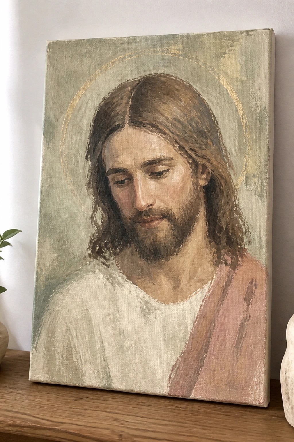 Oil painting of Jesus with long brown hair, beard, golden halo, white robe and pink sash.
