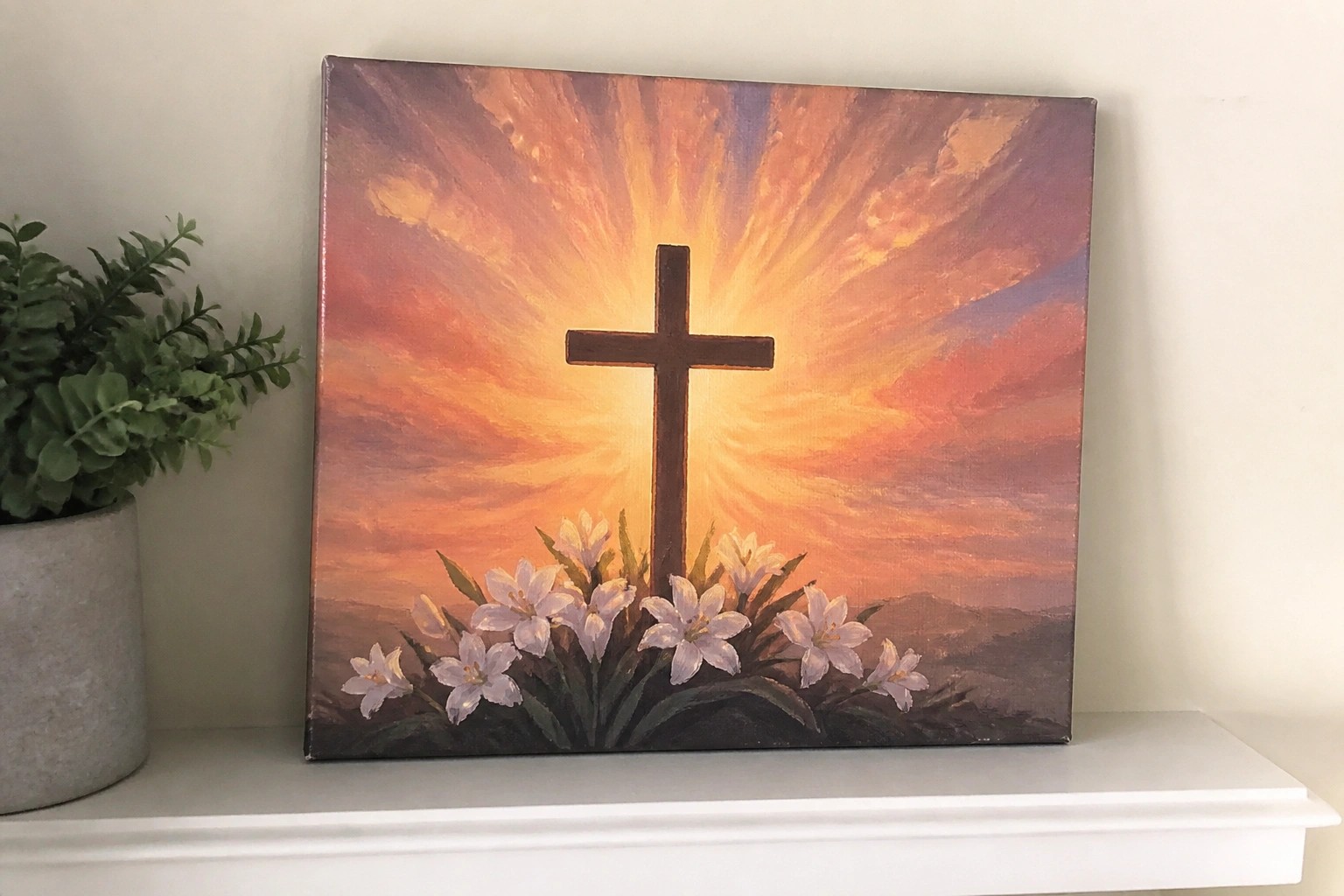 Painting of black cross with white lilies against vibrant orange-purple sunset rays.