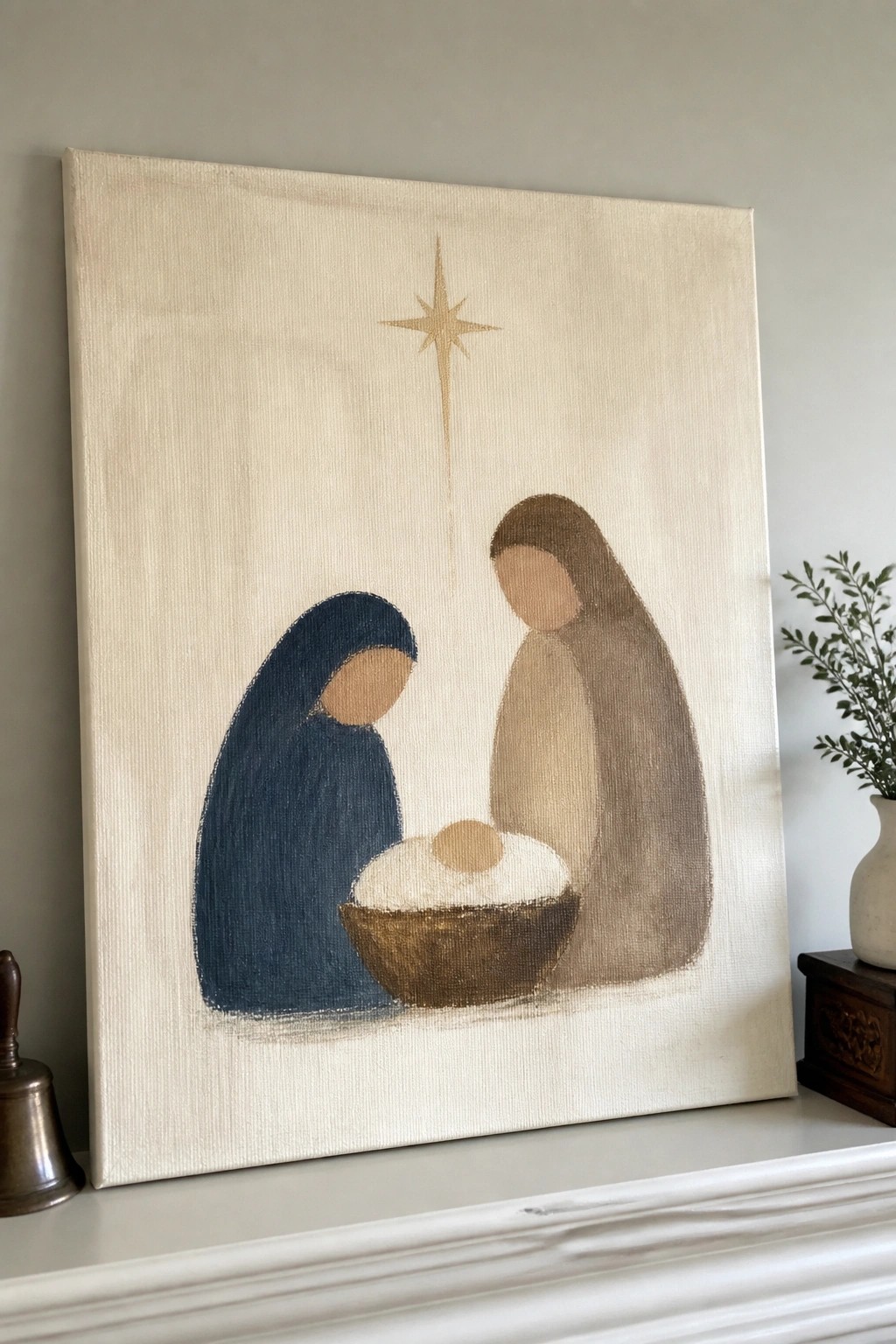 Minimalist canvas painting of blue-robed Mary, brown-robed Joseph, manger with baby, and golden star.