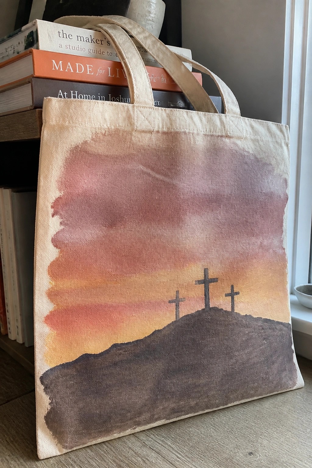 Canvas tote bag with watercolor sunset and three crosses on a hill