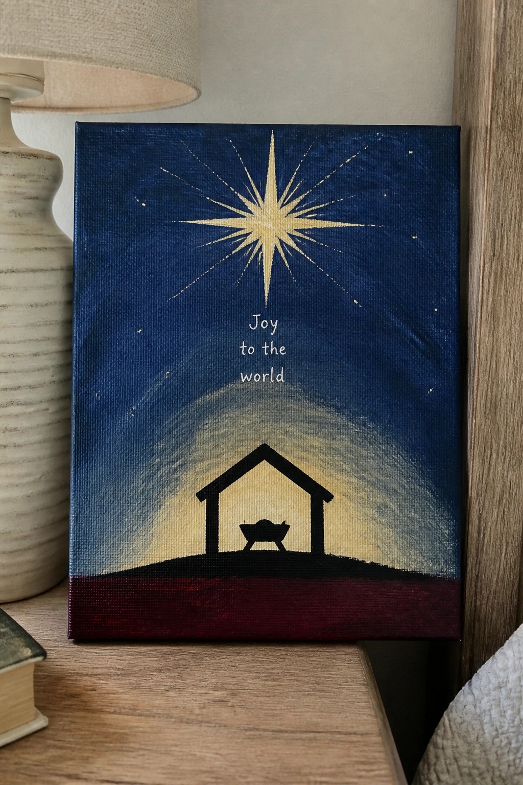 Nativity scene painting with golden starburst, 